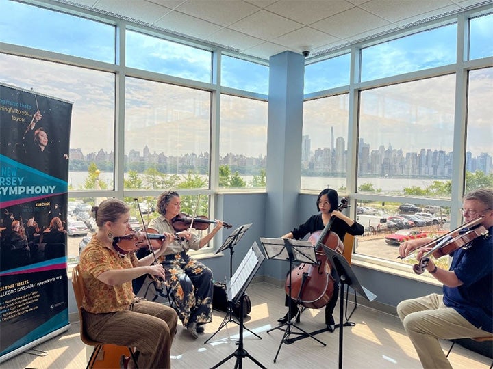 Helen Vassiliou, Ann Kossakowski, Hyewon Kim and Frank Forester performing at Palisades Medical Center
