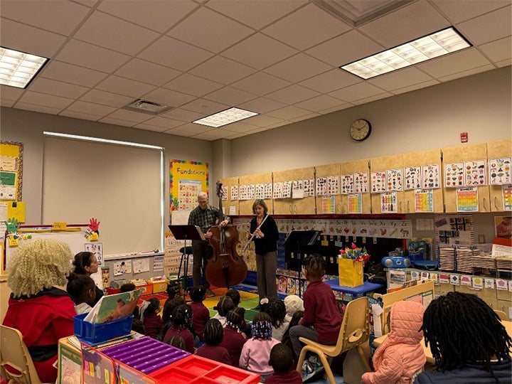 Kathleen Nester and Jonathan Storck performing for preschool kids at the Speedway School in Newark